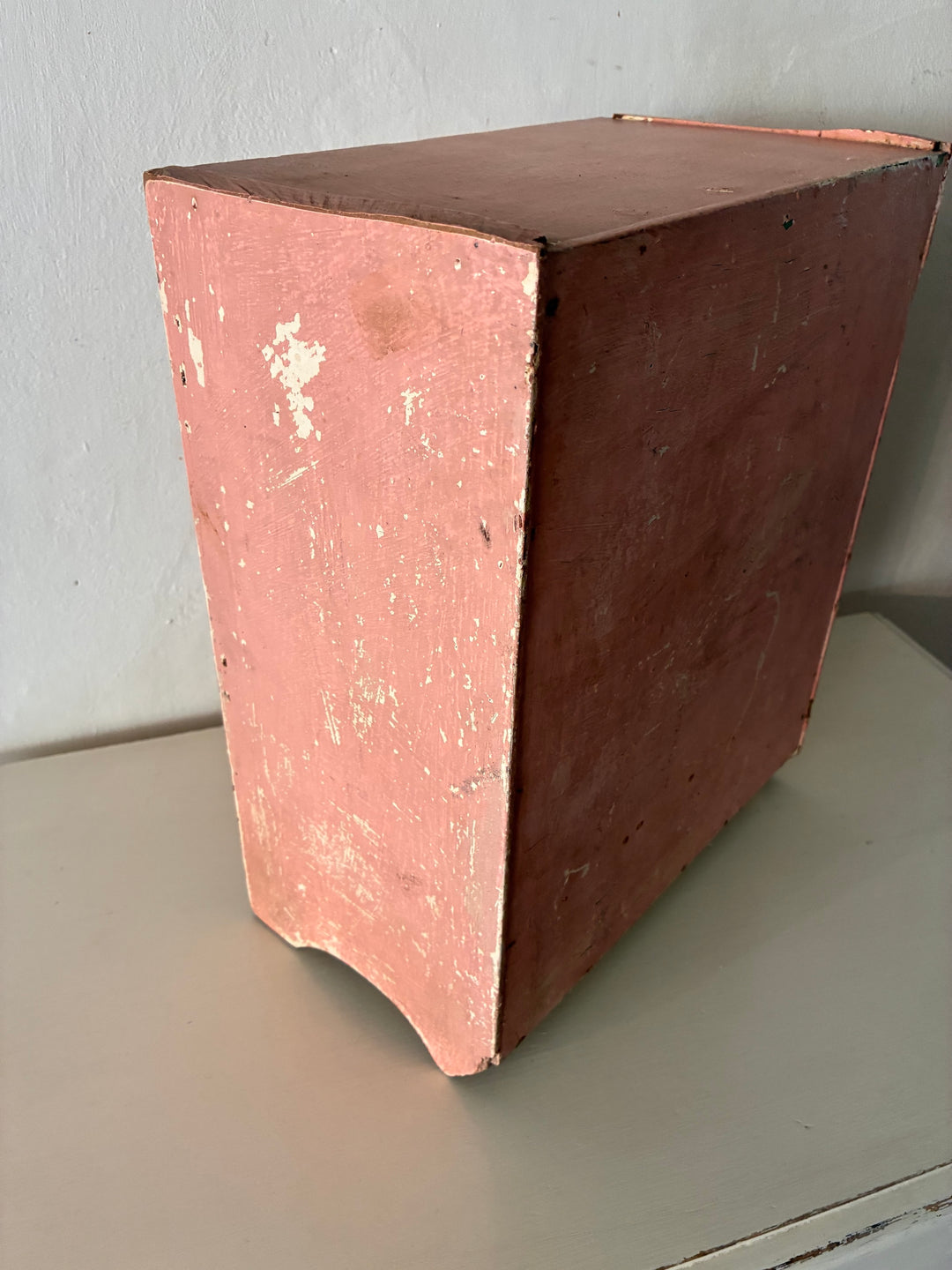 Small vintage salmon pink wall cupboard with distressed finish, ideal for rustic kitchens and bathrooms by Source for the Goose, Devon.