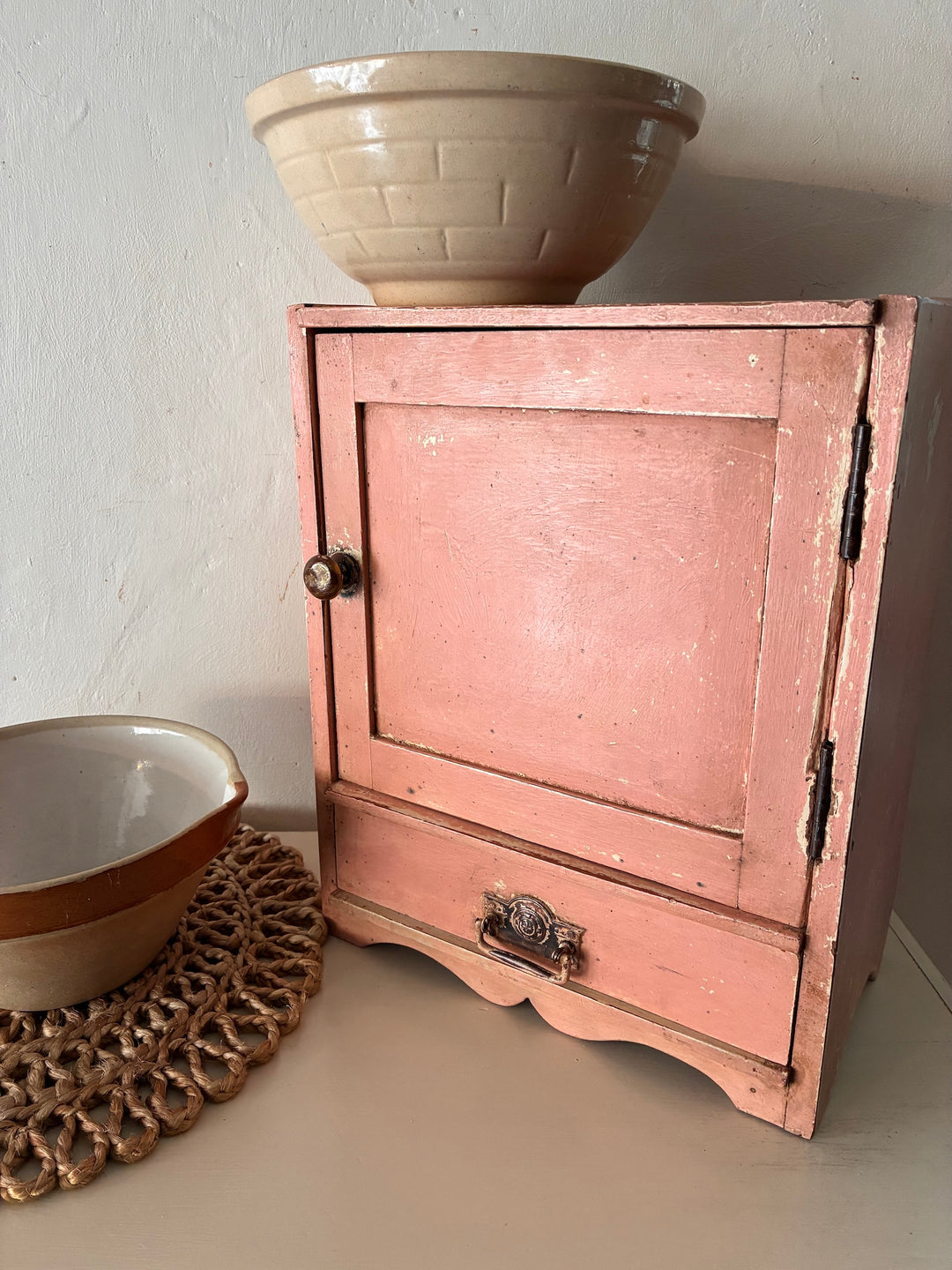 Small vintage salmon pink wall cupboard with antique handles, perfect for country kitchens from Source for the Goose, Devon.