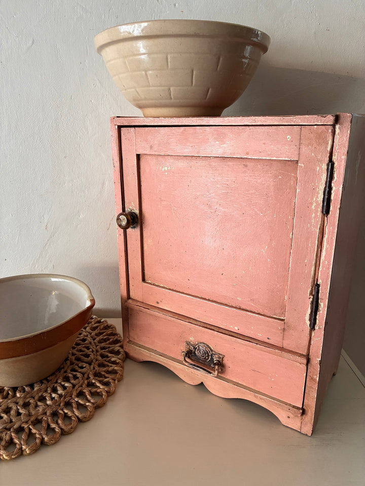 Small vintage salmon pink wall cupboard with antique handles, perfect for country kitchens from Source for the Goose, Devon.