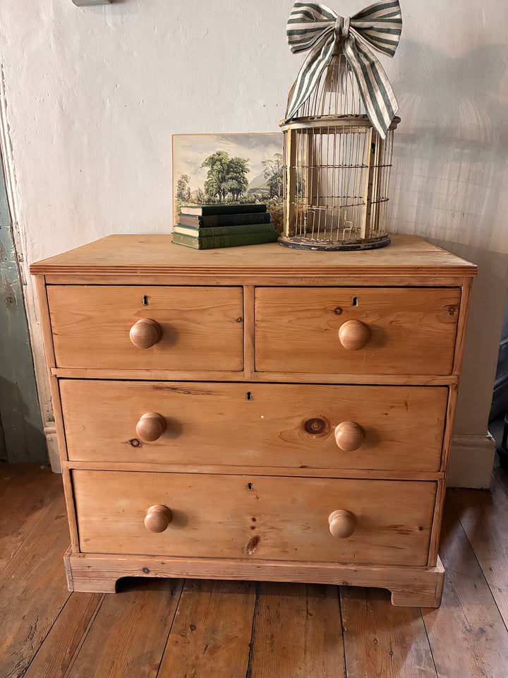 Small Antique Victorian Pine Chest of Drawers showcased with books and a birdcage, perfect for vintage home decor in Devon.