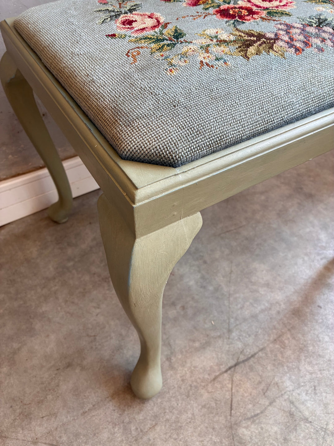 Vintage Stool with Floral Cushion showcasing sage green cabriole legs and a floral needlepoint cushion.