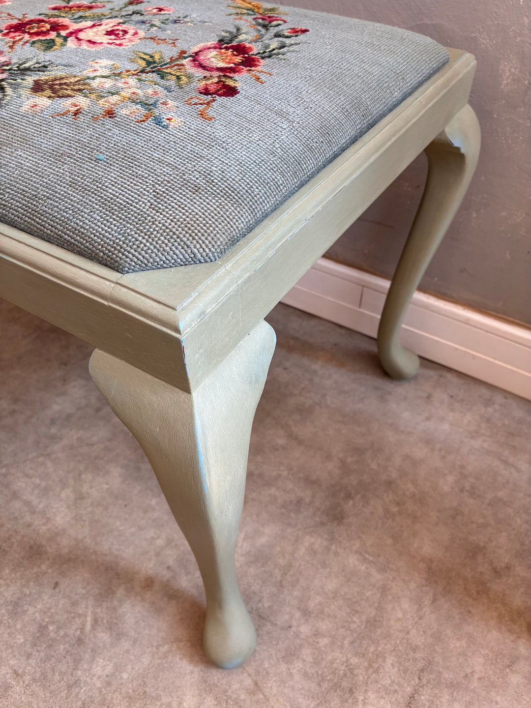 Vintage Stool with Floral Cushion showcasing sage green cabriole legs and floral needlepoint cushion.