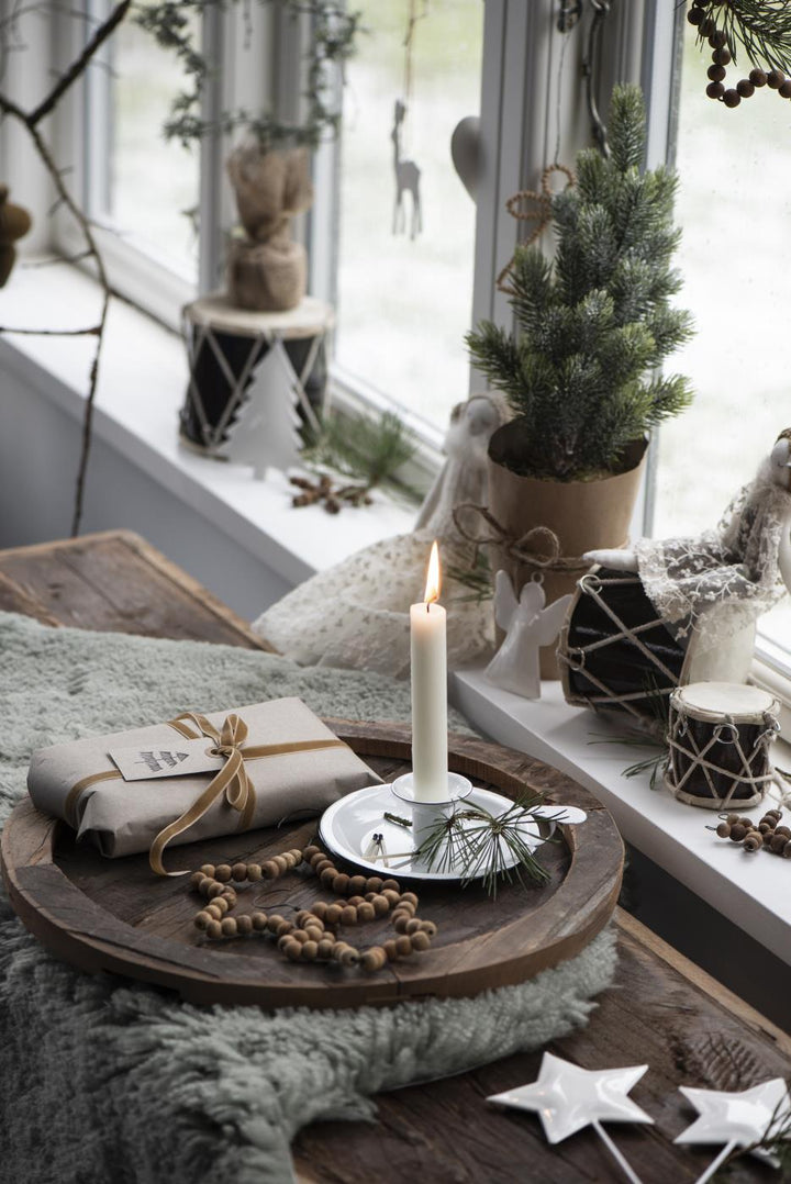 white candle holder as part of Christmas display