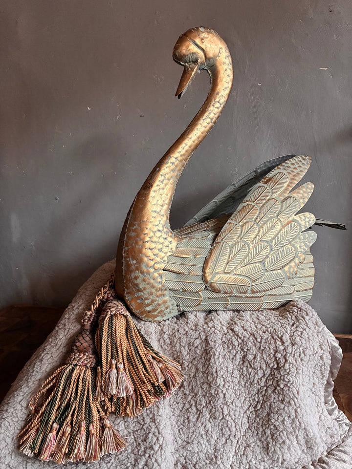 Regal Verdigris Decorative Swan with intricate feathers and charming tassels on a soft surface.