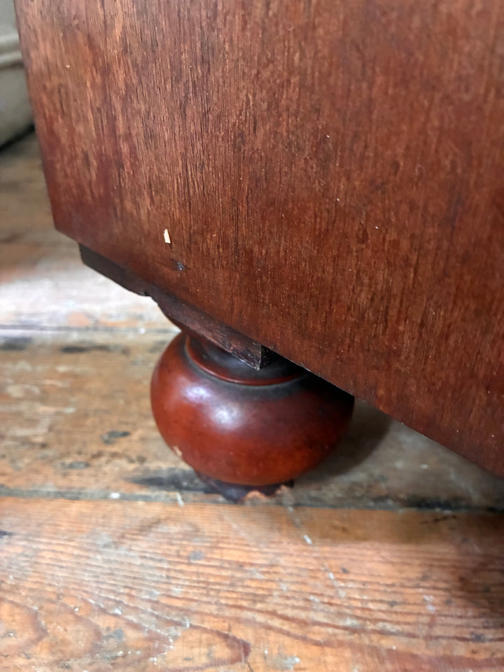 Close-up of a turned foot of a Large Victorian Mahogany Chest of Drawers, showcasing intricate craftsmanship.