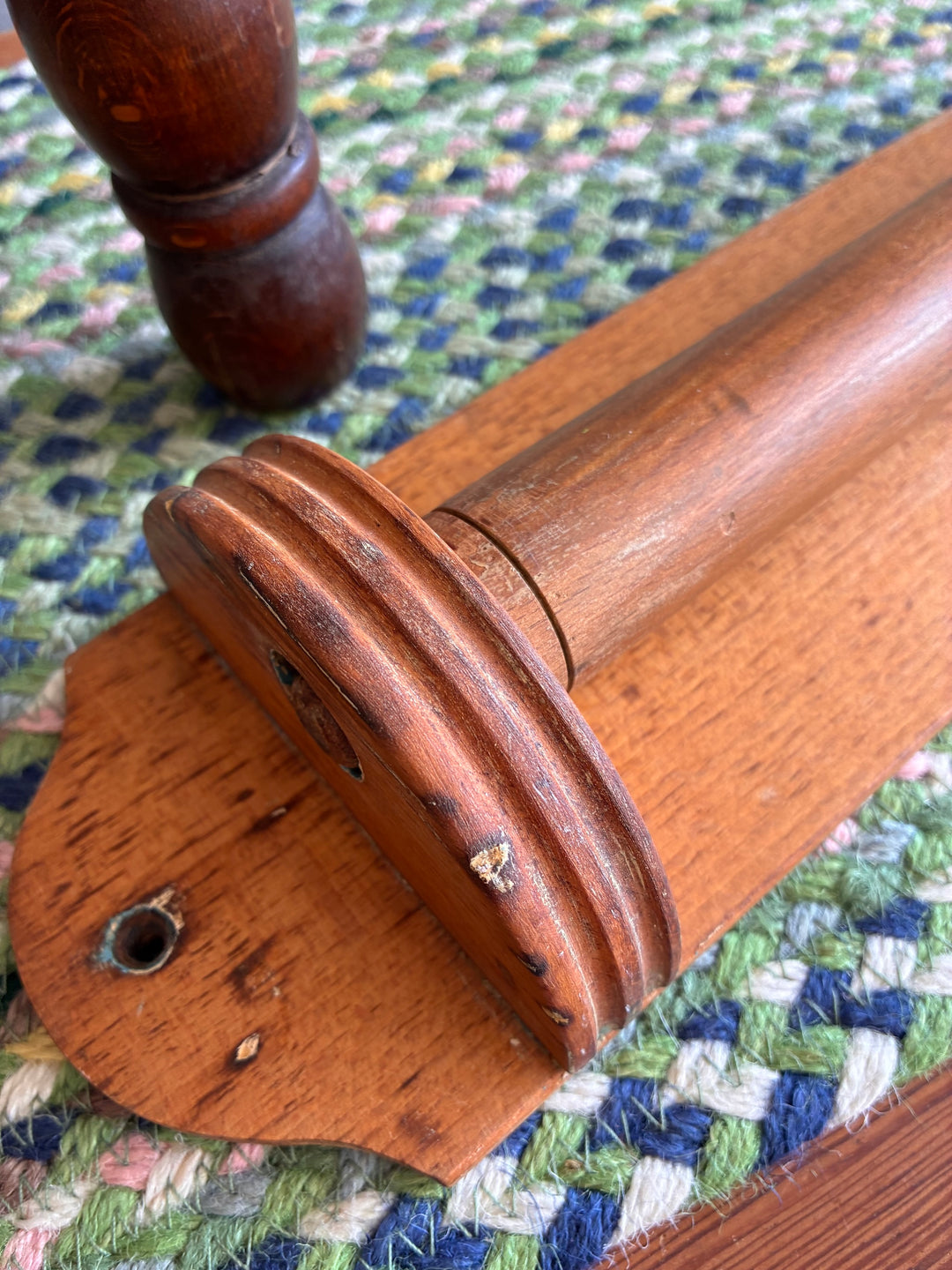 Vintage French wooden towel holder showcasing rustic charm with a warm pine finish, perfect for kitchens or bathrooms.