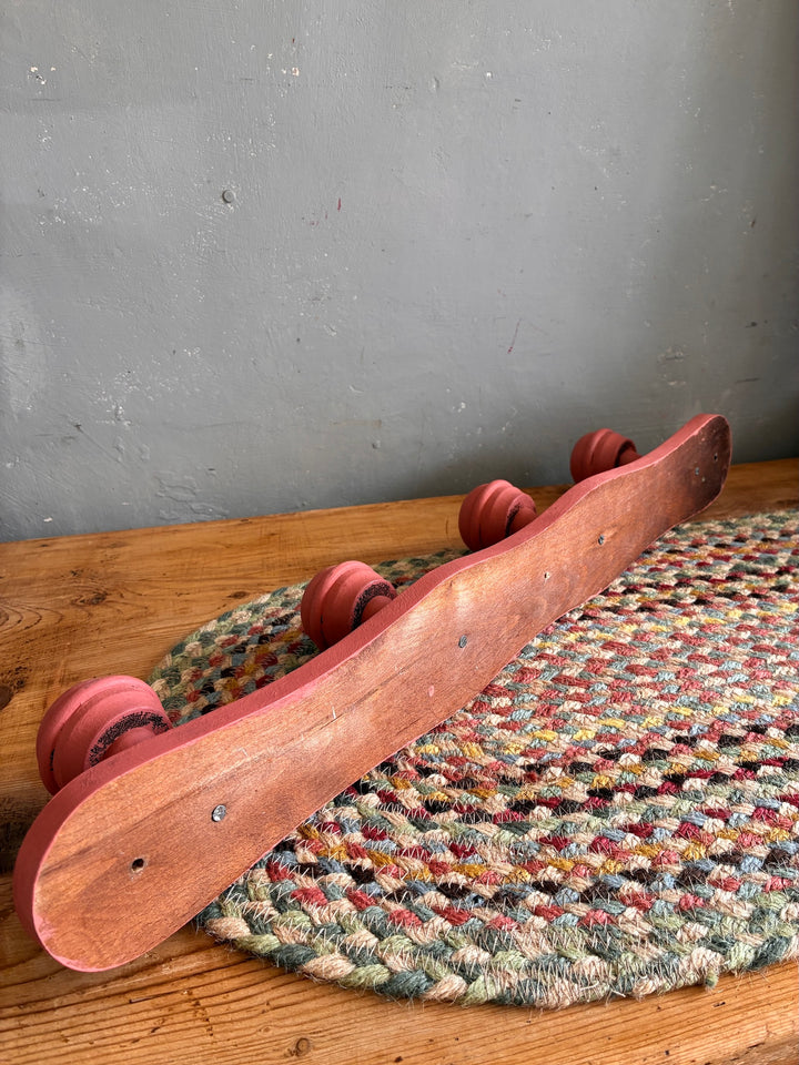 Earthy Pink Vintage French Coat Hooks displayed on a textured rug, showcasing its charming salmon pink finish.