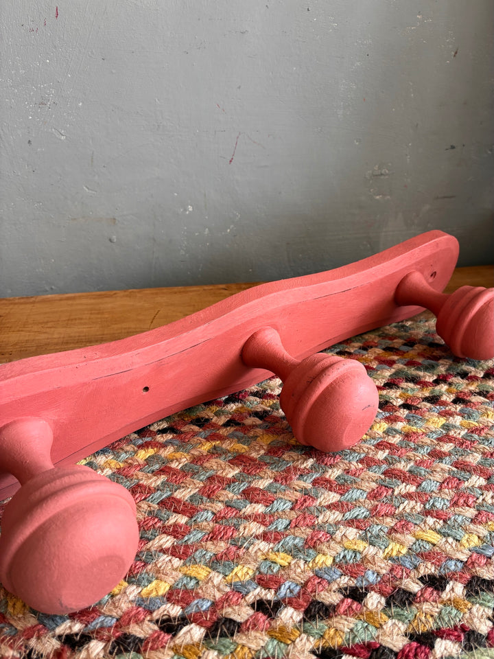 Earthy Pink Vintage French Coat Hooks on a woven fabric background, showcasing their charming design.