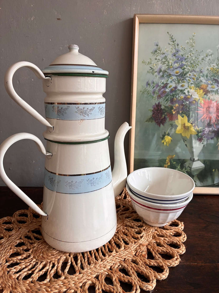 Vintage French coffee pot in wedgewood blue with gold accents, displayed with bowls on a handmade mat. Source for the Goose, Devon.