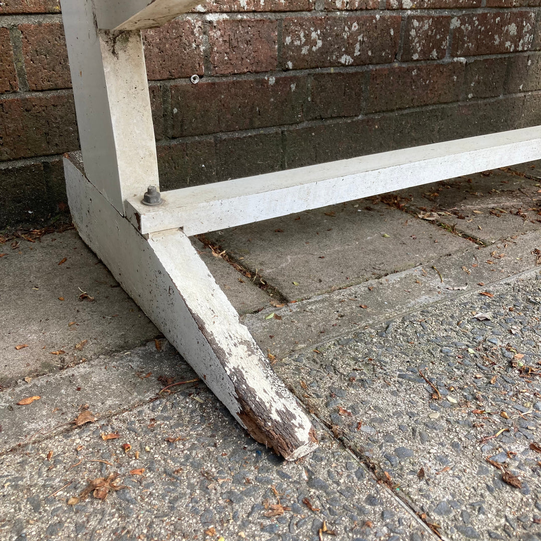 small area of damage on white garden bench