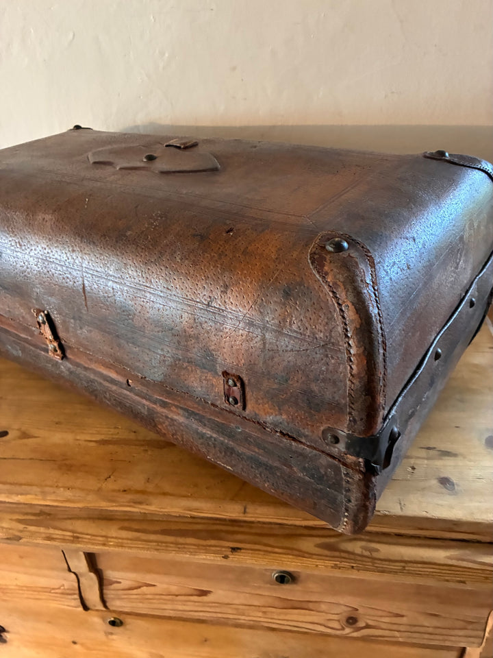 Vintage French Leather Suitcase showcasing well-worn patina and rounded corners, perfect for travel enthusiasts.