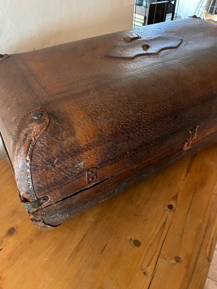 Vintage French Leather Suitcase showcasing a well-worn patina and unique character for travel enthusiasts.