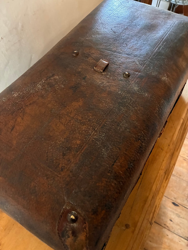 Vintage French Leather Suitcase showcasing well-worn patina and charming character for travel enthusiasts.