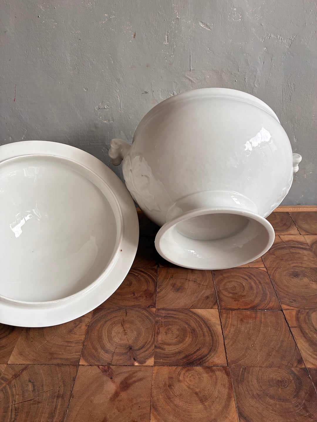 Vintage White Porcelain French Tureen displayed elegantly on a wooden surface, showcasing intricate details and classic design.