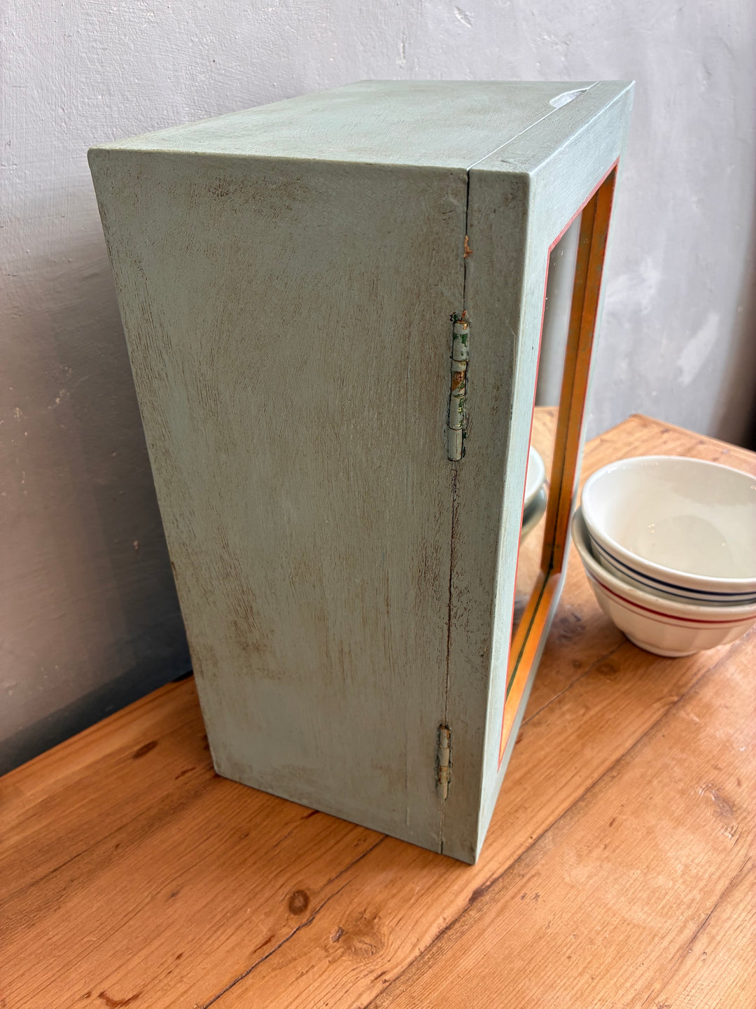Vintage mirrored wall cabinet in soft blue with rustic design, perfect for bathroom or quirky kitchen storage.