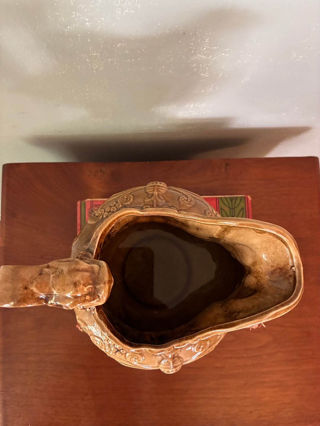 Vintage Neptune Pottery Jug top view showcasing its intricate design and warm brown glaze.