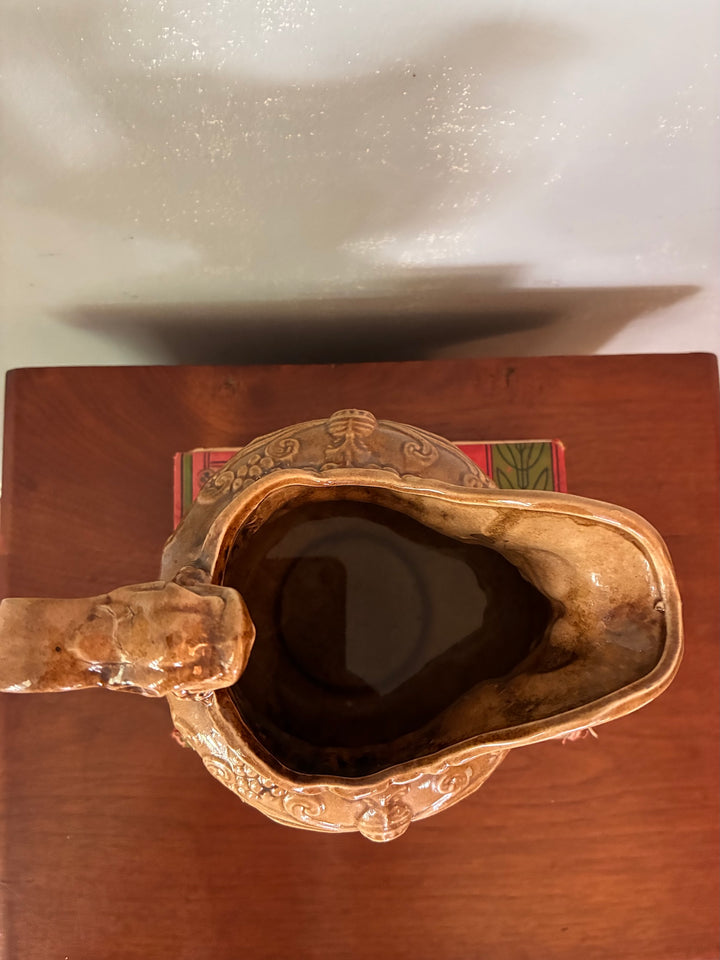 Vintage Neptune Pottery Jug top view showcasing its intricate design and warm brown glaze.