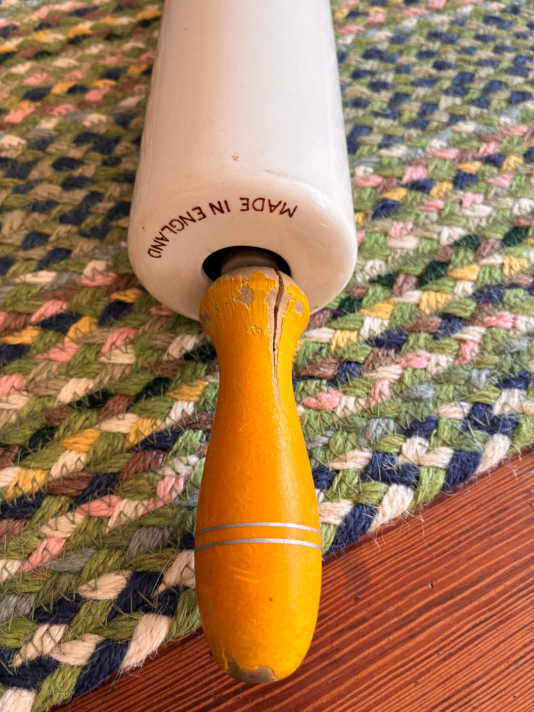 Vintage Nutbrown rolling pin with yellow handles, made in England, perfect for collectors and baking enthusiasts.