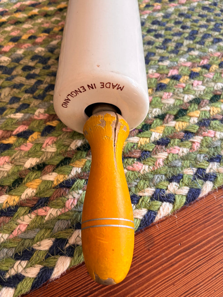 Vintage Nutbrown rolling pin with yellow handles, made in England, perfect for collectors and baking enthusiasts.