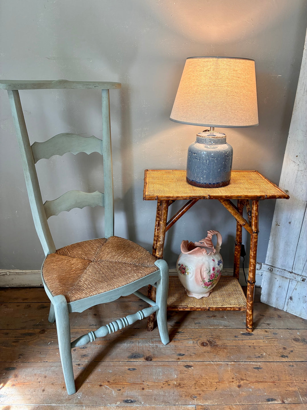 French Vintage Painted Prayer Chair - Prie Dieu beside a rustic table and lamp, showcasing classic European craftsmanship.