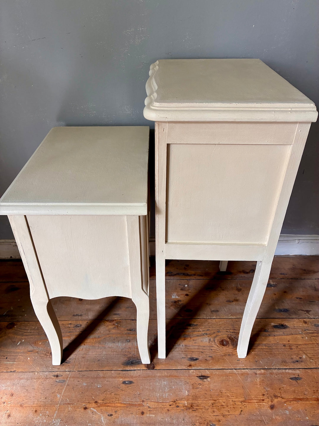 Vintage Painted French Bedside Tables - His and Hers side view on wooden floor, showcasing elegant design and fluted legs.