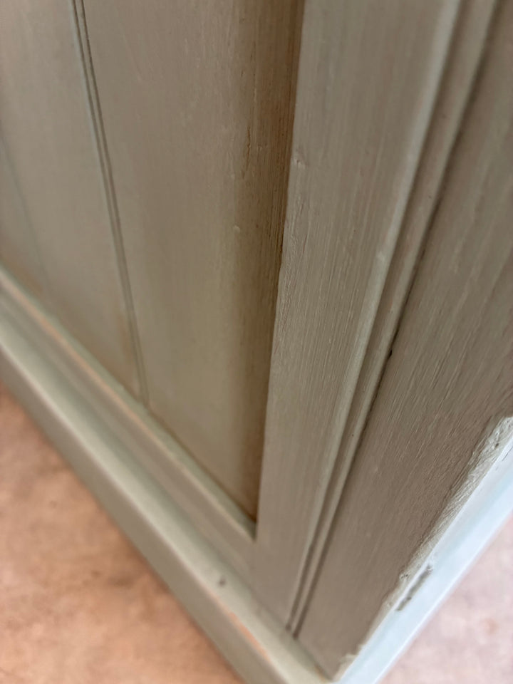 Close-up of the vintage painted pot cupboard in duck egg blue, showcasing its rustic finish and wooden texture.