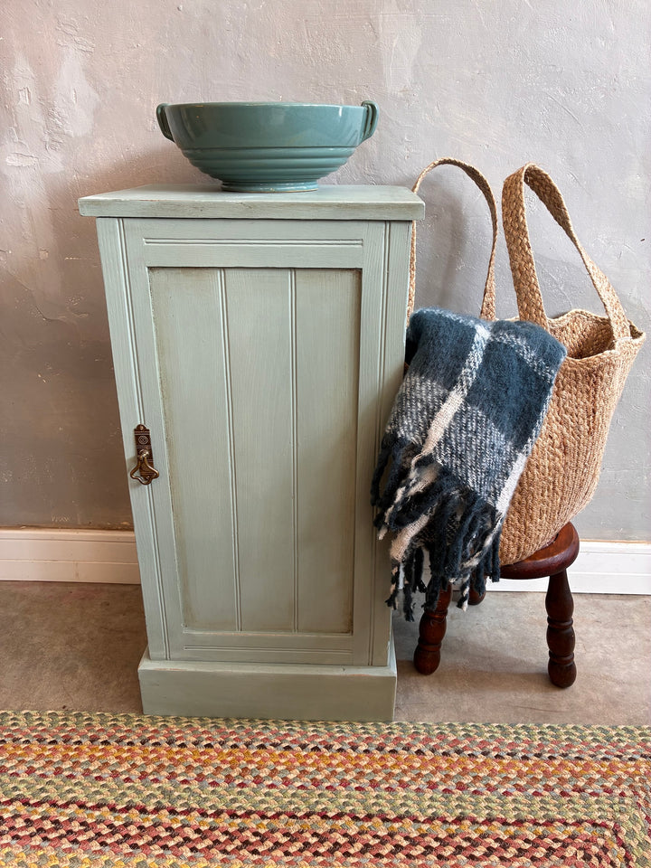 Vintage painted pot cupboard in duck egg blue with brass handle, styled with basket, plaid blanket, and bowl - Source for the Goose, Devon.