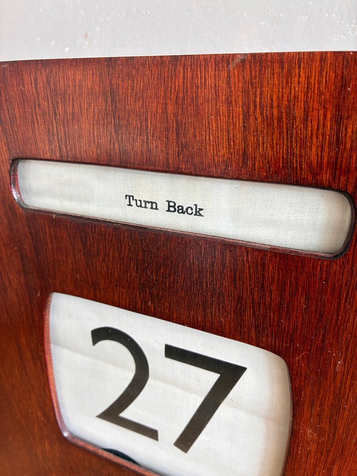 Vintage Wall Hanging Perpetual Calendar close-up showing Turn Back and date 27 on wooden case.