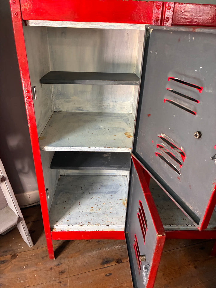 Interior view of Red Metal Four Door Storage Locker showcasing shelves and gray doors with red accents.