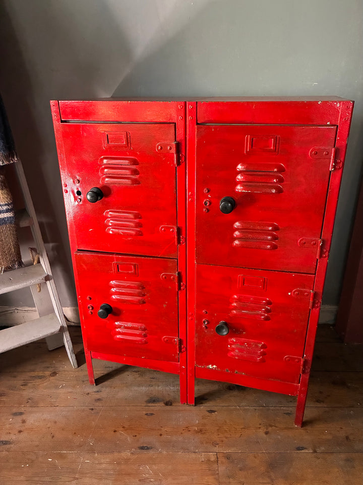 Red Metal Four Door Storage Locker featuring four vented doors and black handles, ideal for stylish organization.