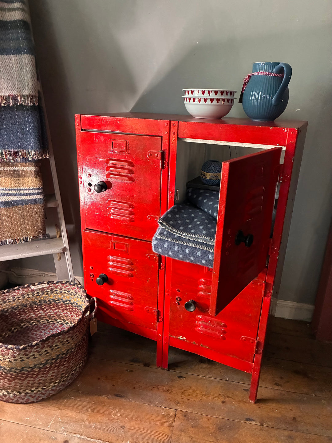 Red Metal Four Door Storage Locker with open doors and decorative items inside, showcasing industrial-chic style.