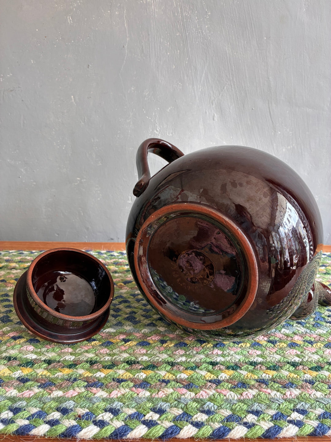 Vintage 6 Pint Brown Betty Teapot and lid on a colorful woven mat, perfect for tea lovers, sourced from Source for the Goose Devon.