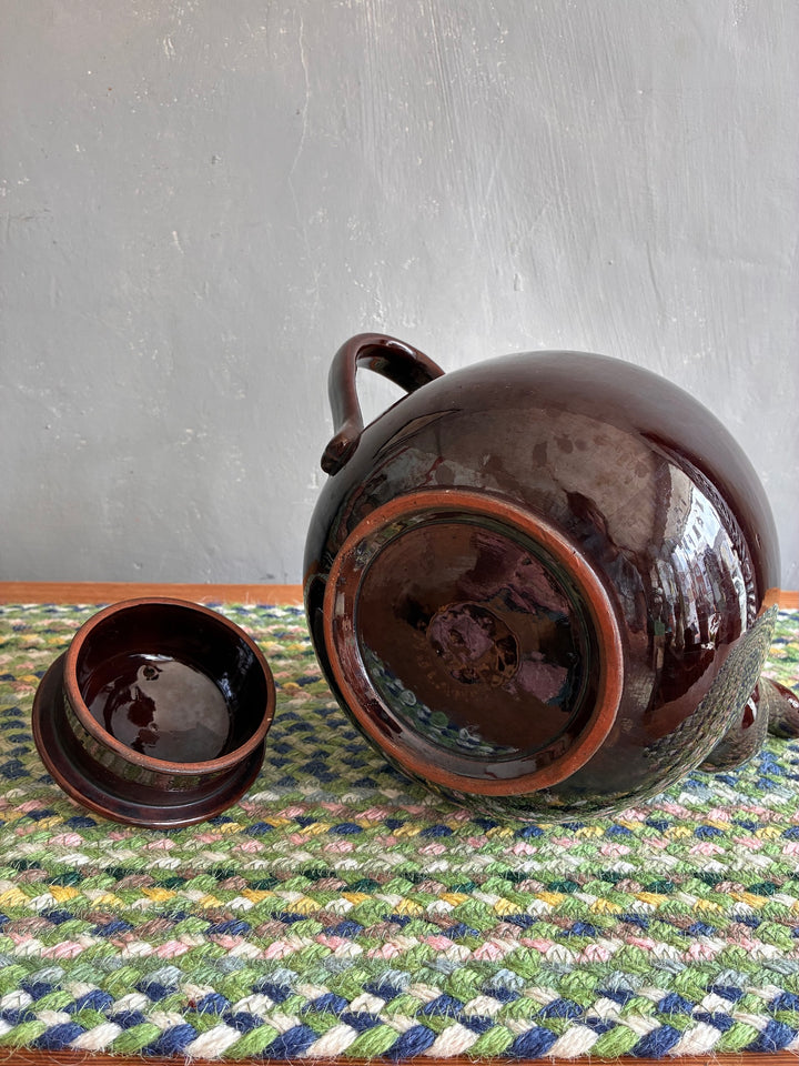 Vintage 6 Pint Brown Betty Teapot and lid on a colorful woven mat, perfect for tea lovers, sourced from Source for the Goose Devon.