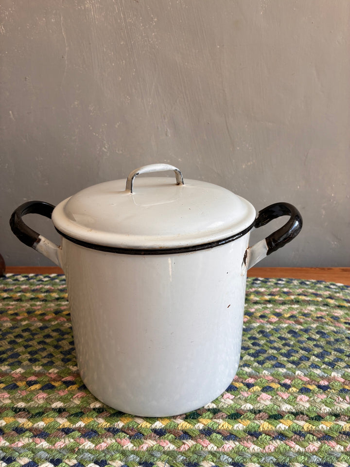 Vintage white flour bin with black handles, perfect for charming kitchen decor and storage.