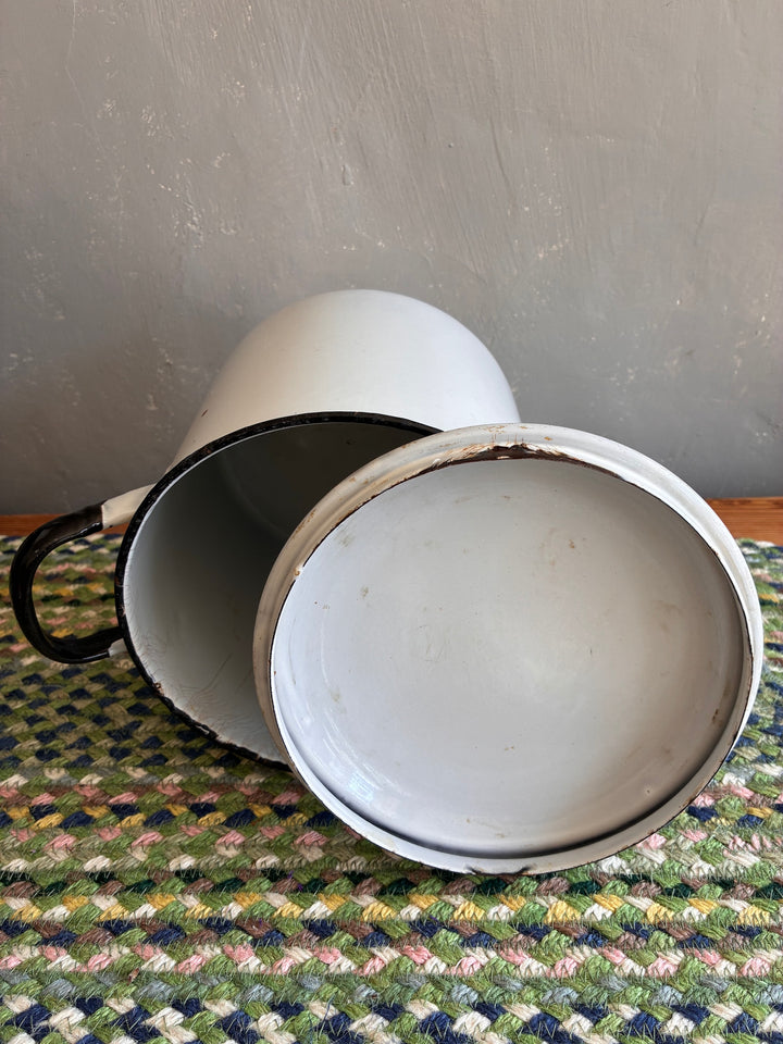 Vintage white tin cup with a worn finish, showcasing nostalgic charm for kitchen decor.