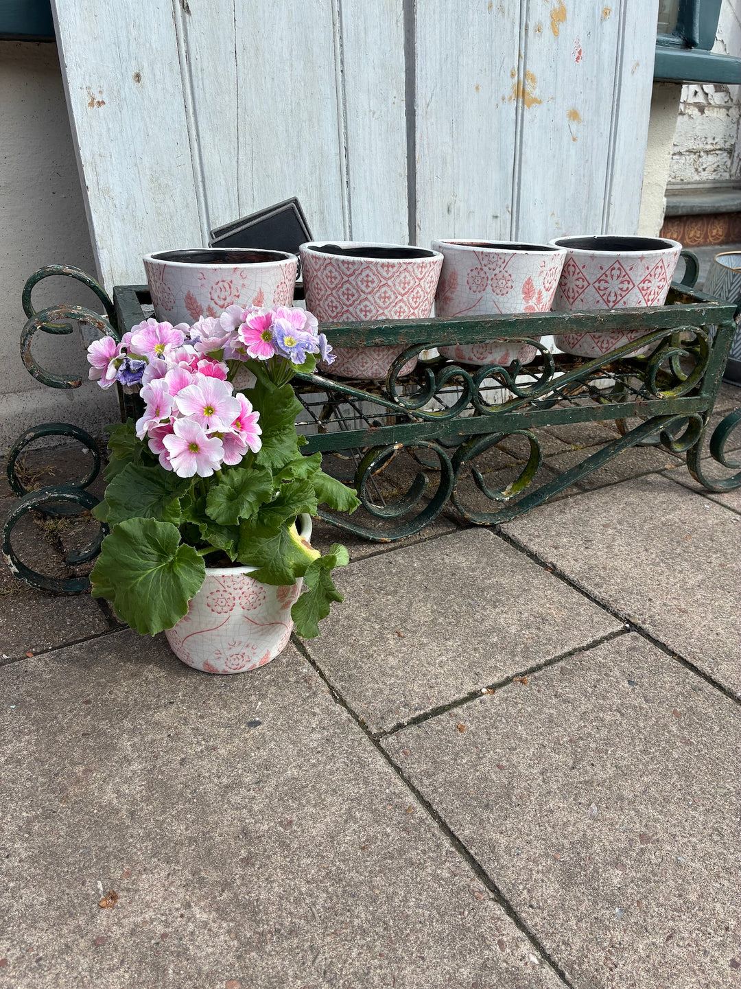 Vintage Painted Wrought Iron Trough Planter with pink flowers, adding rustic charm to any garden from Source for the Goose, Devon.