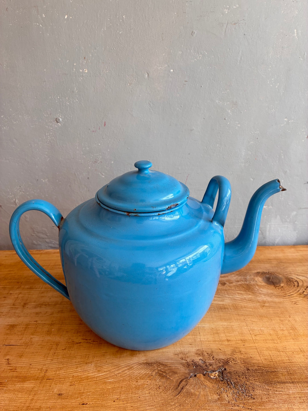 Large Vintage Blue Enamel Teapot on a wooden surface, showcasing its charming robin's egg blue color and dual handles.