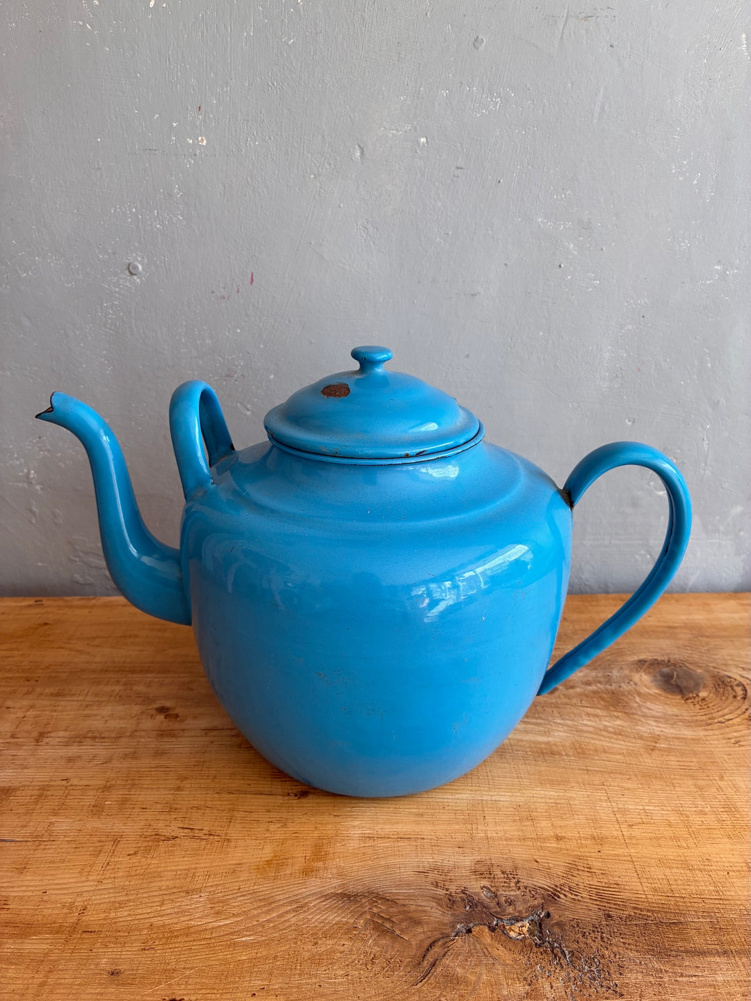 Large Vintage Blue Enamel Teapot on a wooden surface, showcasing its charming robin's egg blue color.