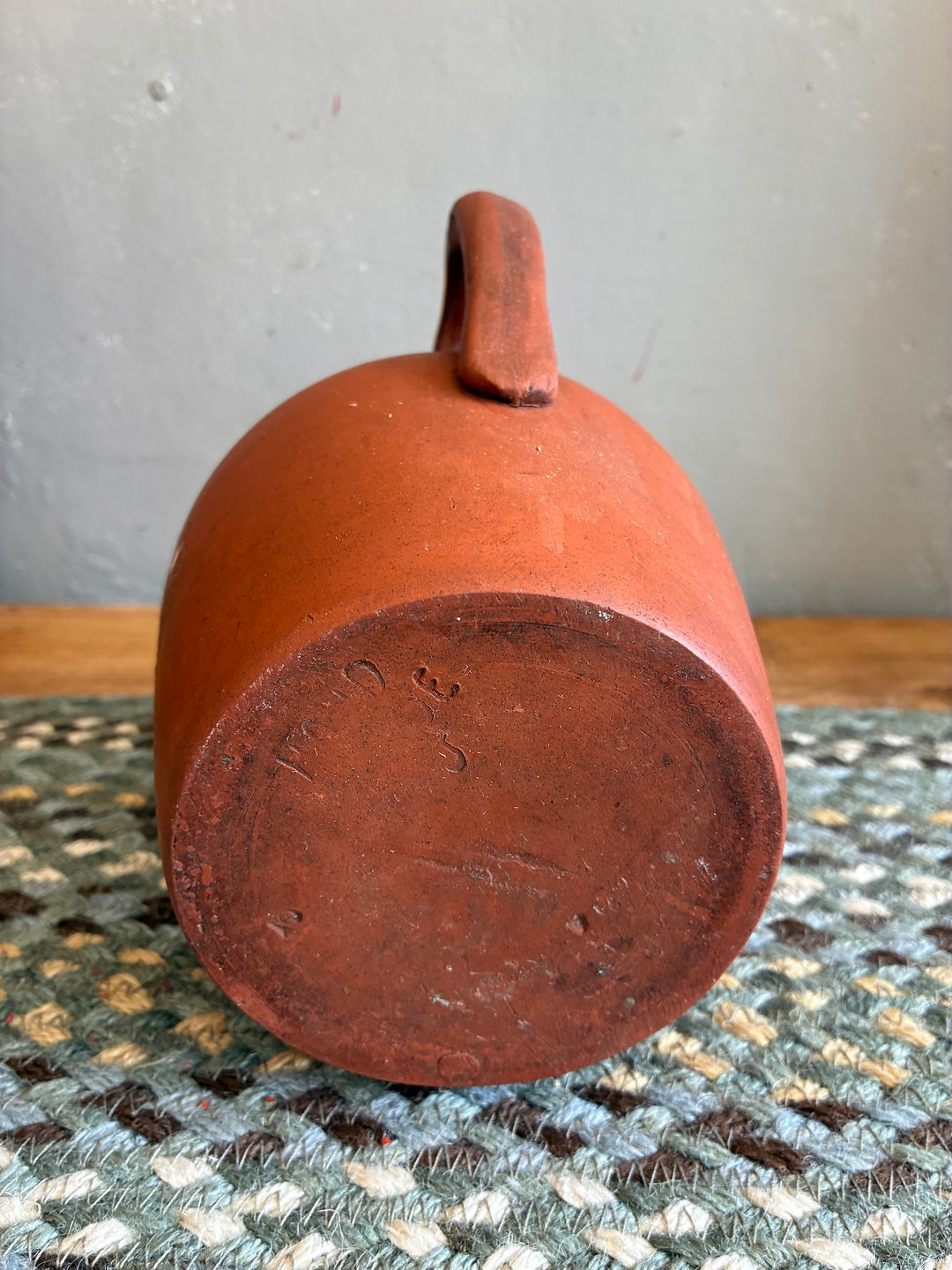 Vintage Terracotta Jug - Yellow Glaze Rim viewed from the bottom showcasing its rustic charm and traditional design.