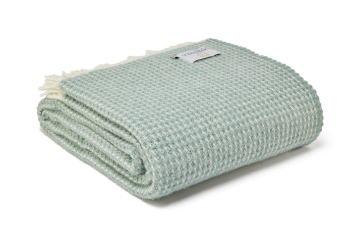 Tweedmill Waffle Sea Green Pure Wool Throw with cream tassels from Source for the Goose, Devon, folded neatly.