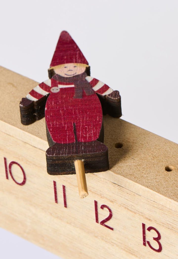 Wooden advent calendar with Santa's helper, enhancing Christmas countdown charm. Source for the Goose, Devon.