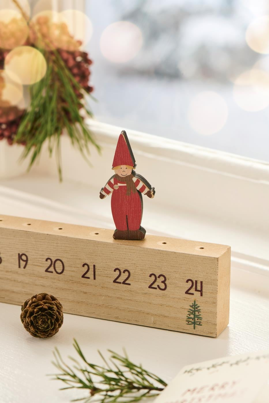 Wooden advent calendar with Santa's helper marking days, perfect for Christmas countdown from Source for the Goose, Devon.