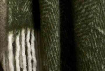 Wool Blend Olive Green Throw with lamb’s tail tassels, perfect for cozy autumn evenings. Source for the Goose Devon.