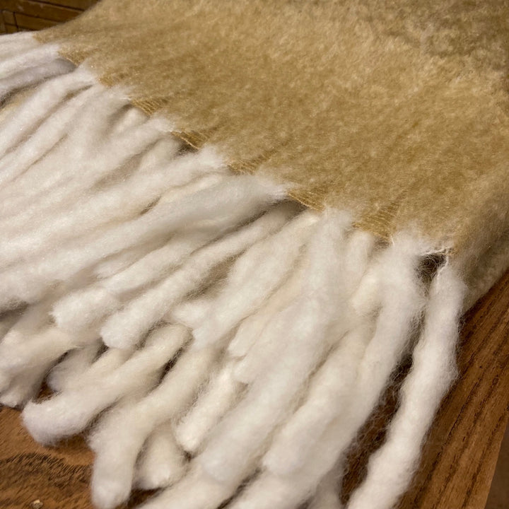 Saffron yellow wool throw with cream lambs tail tassels