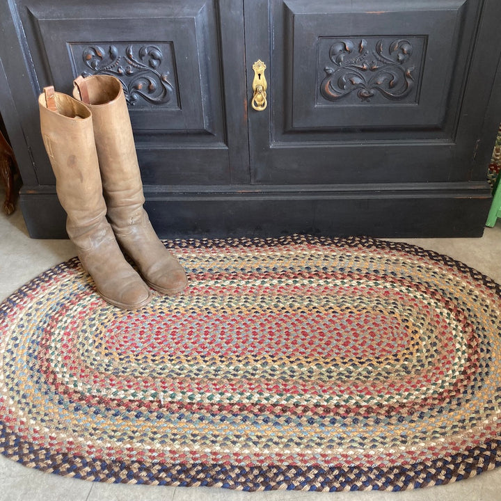 Misty blue oval braided rug at Source for the Goose, Devon, UK